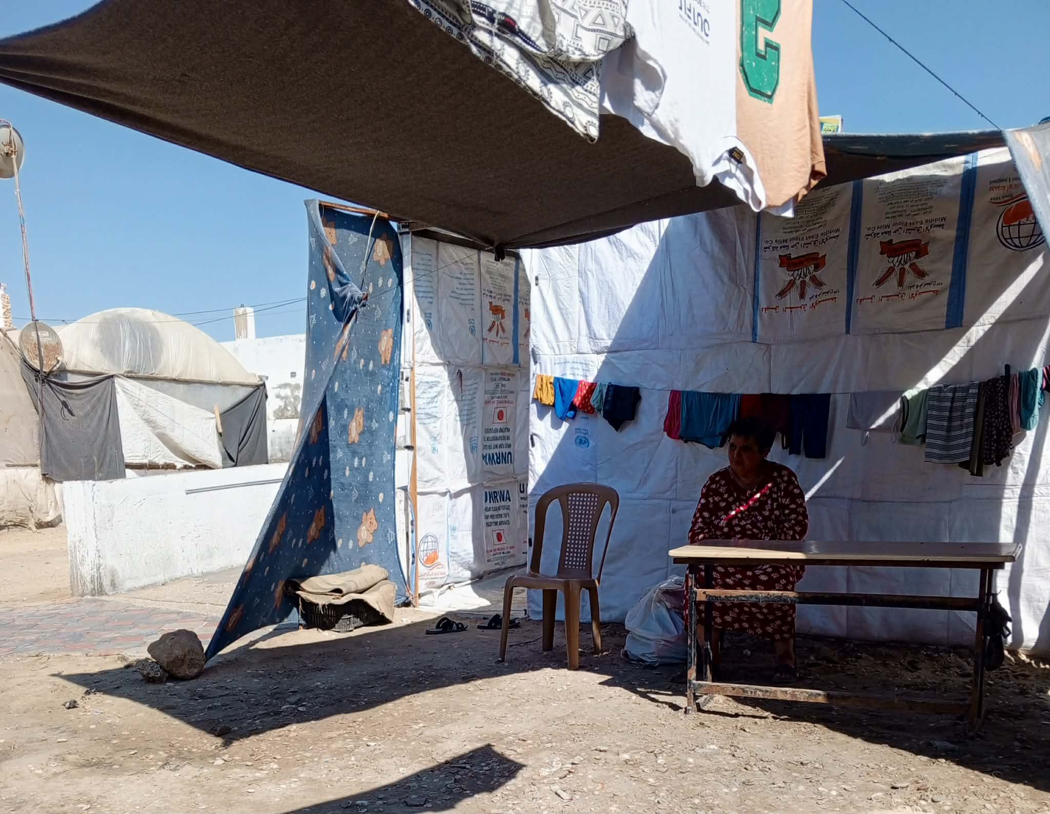 La tenda di Ibtisam Hamad a Deir al-Balah: la sorella Nihaya, con cui abita, cerca di ripararsi sotto un tendone&nbsp;