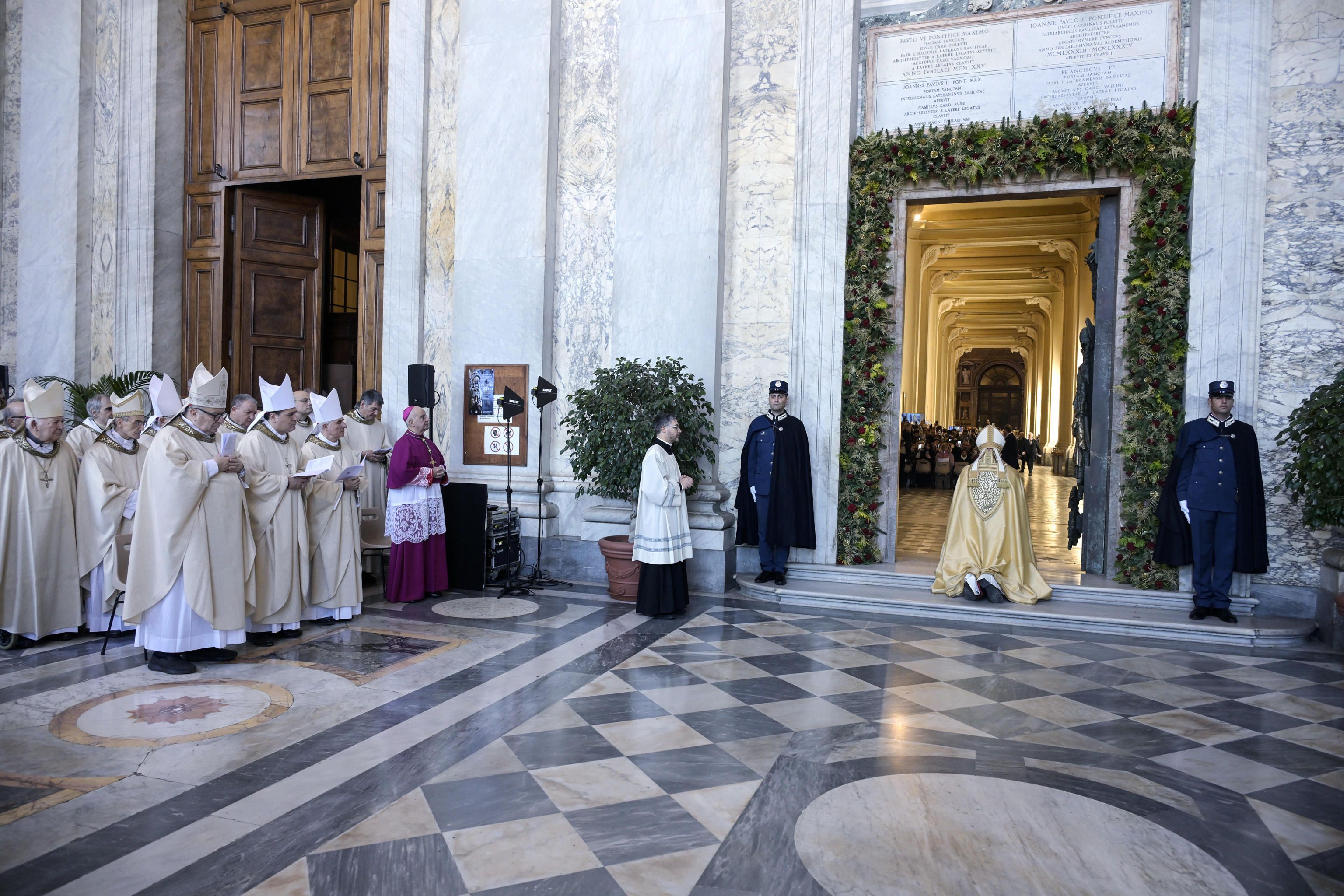 Il cardinale vicario Baldo Reina prega in silenzio davanti alla Porta Santa della Basilica di San Giovanni in Laterano, 27 dicembre 2025 - (ANSA)