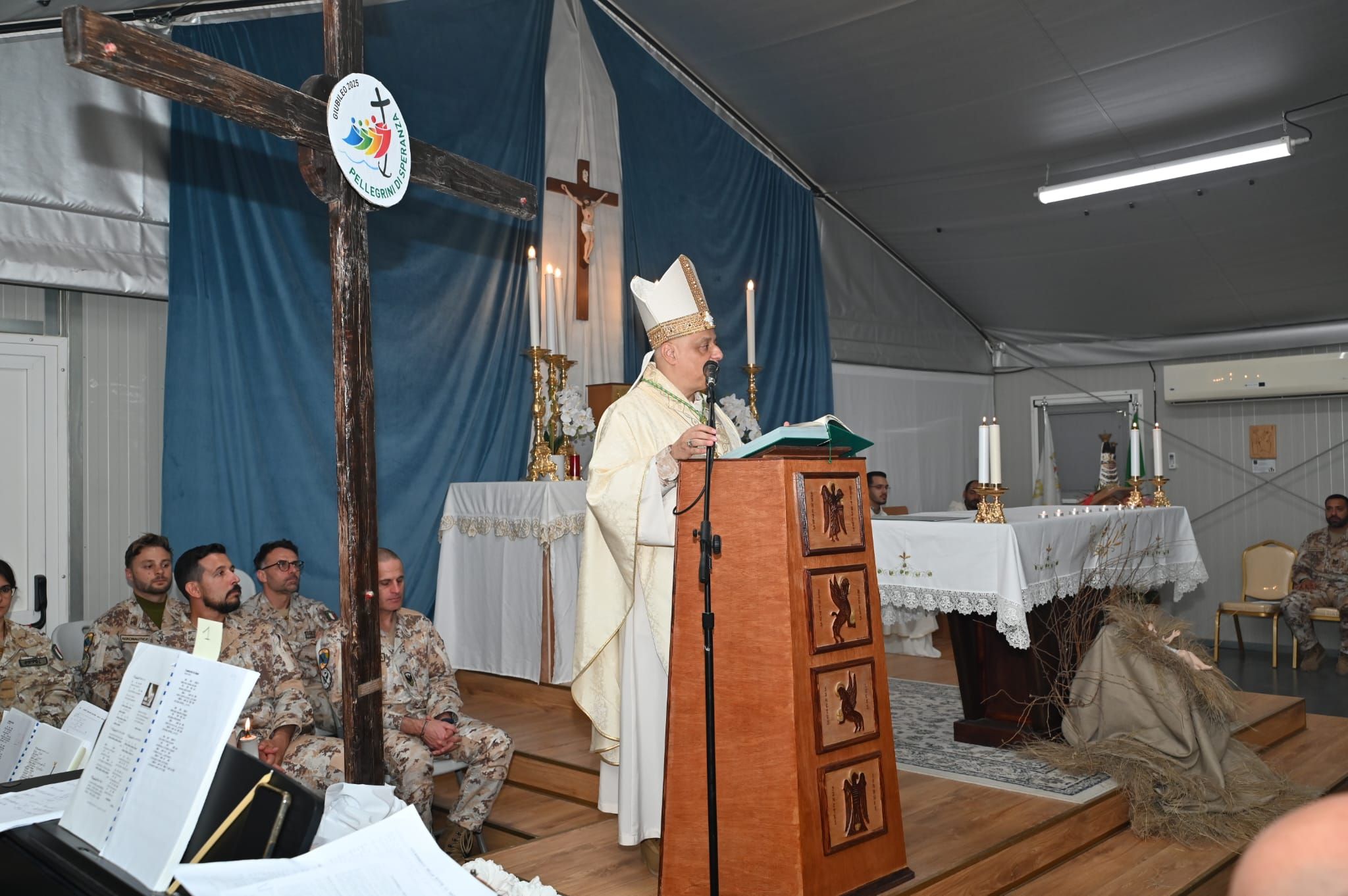 Un momento della celebrazione eucaristica con l'arcivescovo e ordinario militare Saba con accanto la croce in cui campeggia il logo del Giubileo 2025/Ordinariato militare
