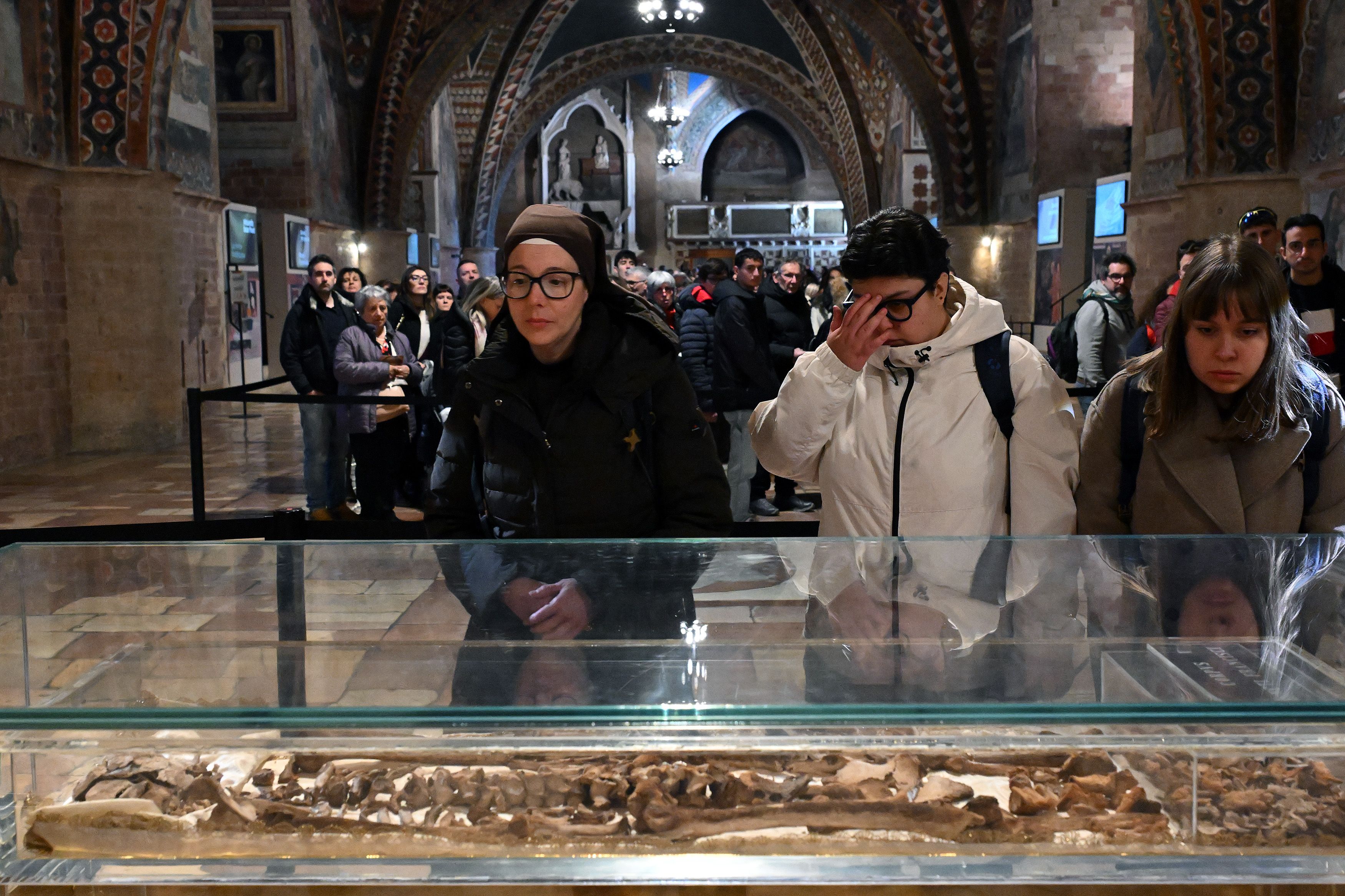 Alcuni fedeli davanti alle ossa del Poverello / Catholic Press Photo